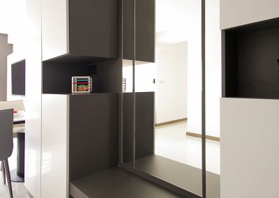 Customized carpentry works to maximize storage space yet allowing lots of living space throughout the entire home with a hidden workstation tucked into the corner of the living room. With a mix of neutral tone laminates, soft furnishing and well placed lightings iluminates the entire area and brings about a cosy tone to the enviroment.