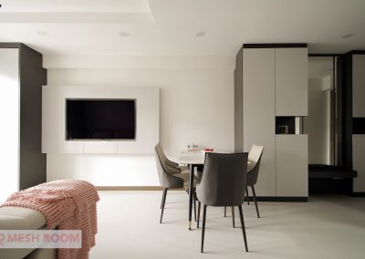 Customized carpentry works to maximize storage space yet allowing lots of living space throughout the entire home with a hidden workstation tucked into the corner of the living room. With a mix of neutral tone laminates, soft furnishing and well placed lightings iluminates the entire area and brings about a cosy tone to the enviroment.