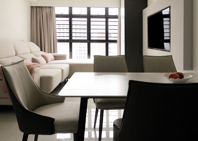 Customized carpentry works to maximize storage space yet allowing lots of living space throughout the entire home with a hidden workstation tucked into the corner of the living room. With a mix of neutral tone laminates, soft furnishing and well placed lightings iluminates the entire area and brings about a cosy tone to the enviroment.